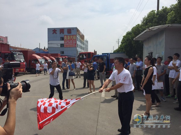 東風(fēng)汽車股份有限公司副總經(jīng)理劉耀平揮動(dòng)上海站發(fā)車旗